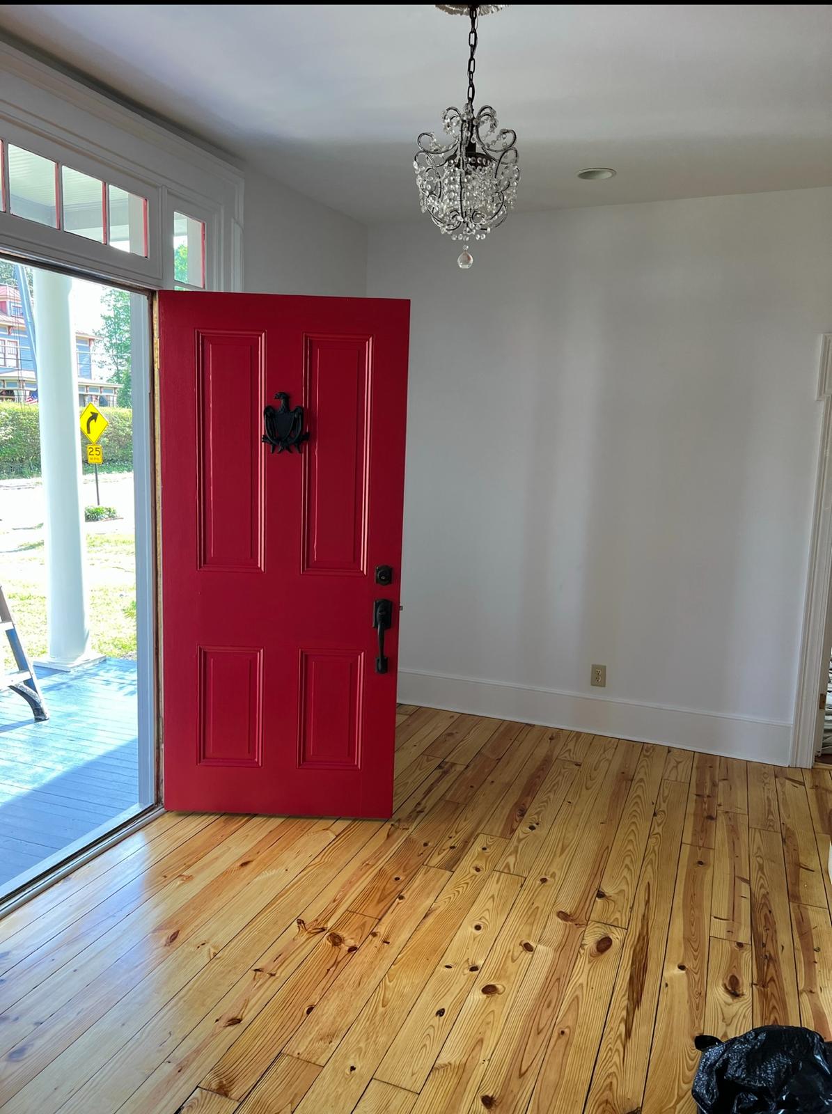 Freshly painted red front door with white interior trim