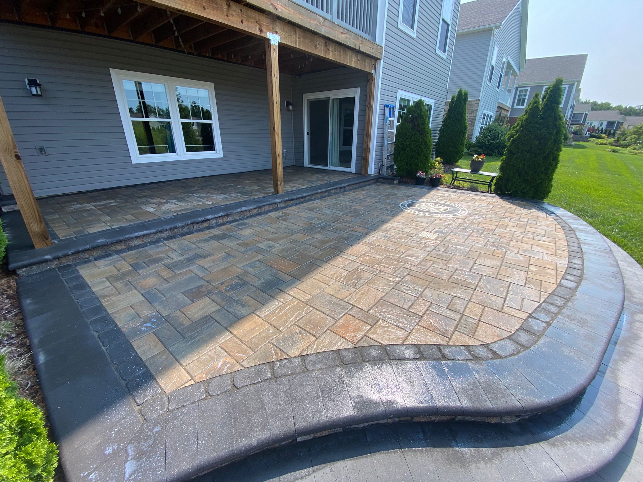 Paver patio beneath a covered porch