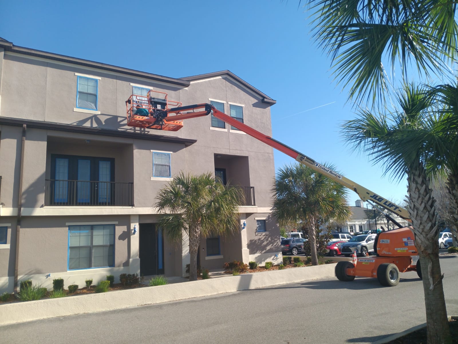 Apartment building repaint with boom lift
