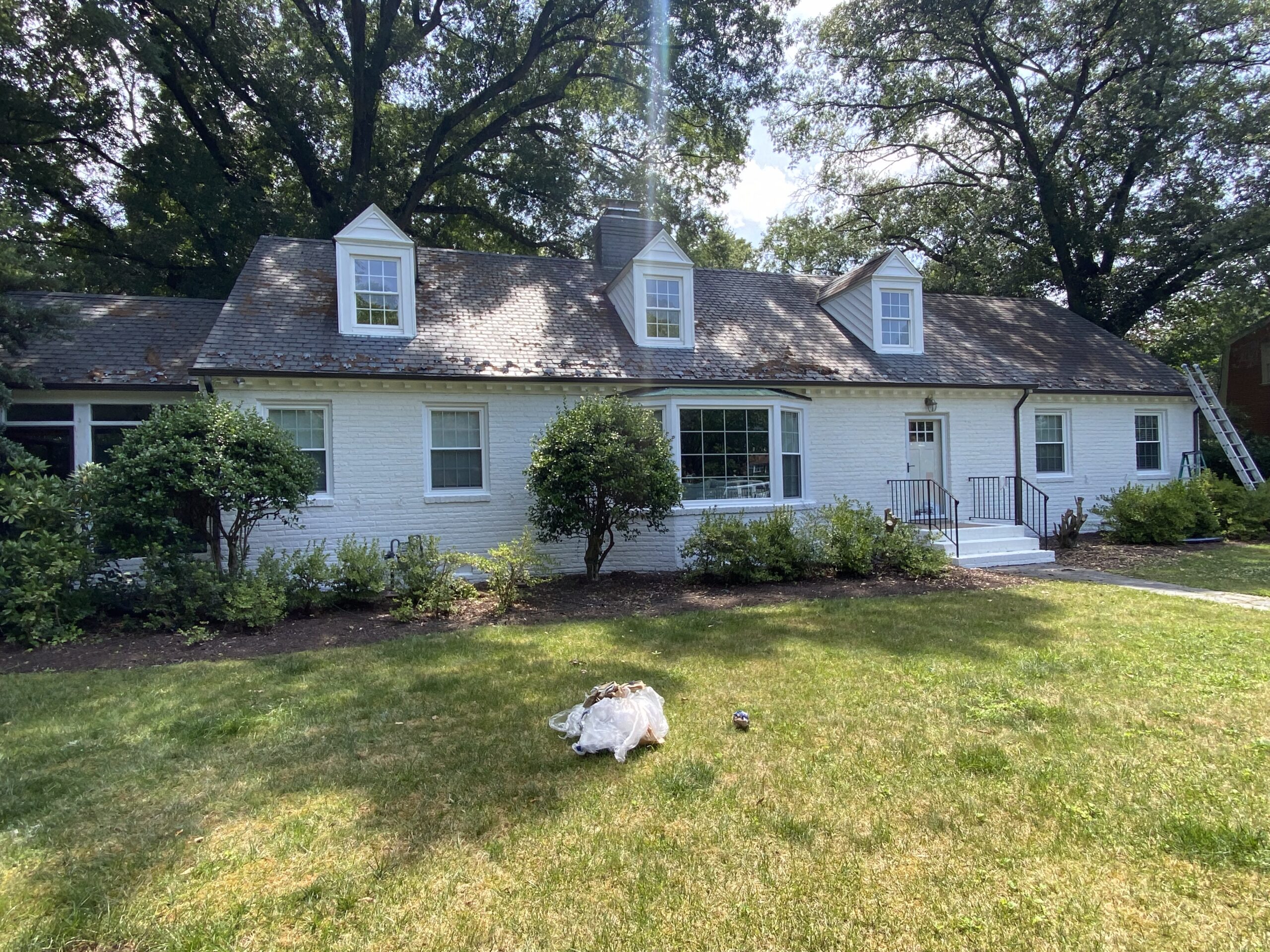 Cottage exterior repaint with dormer windows