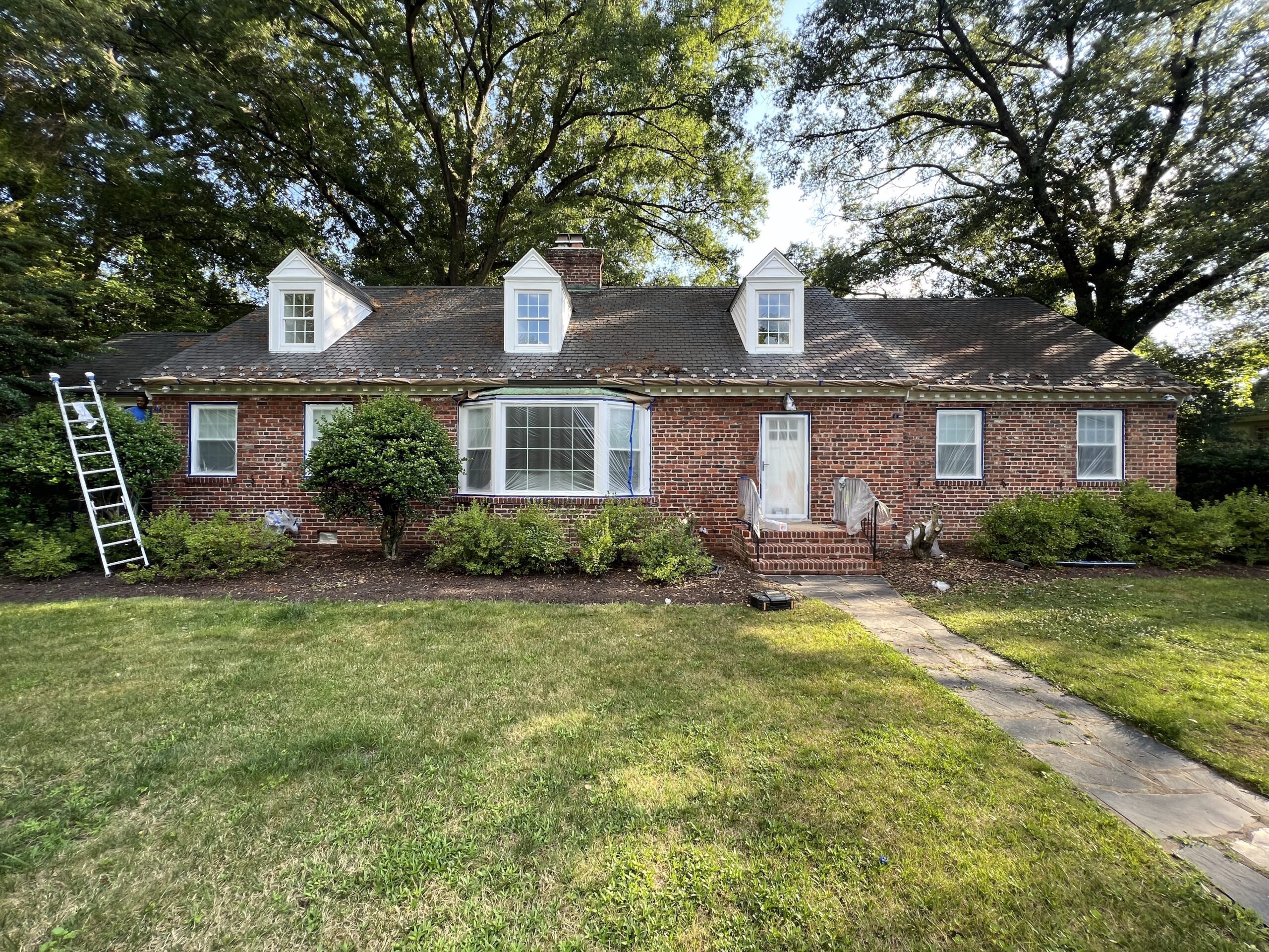 Brick home with white painted dormers and shutters