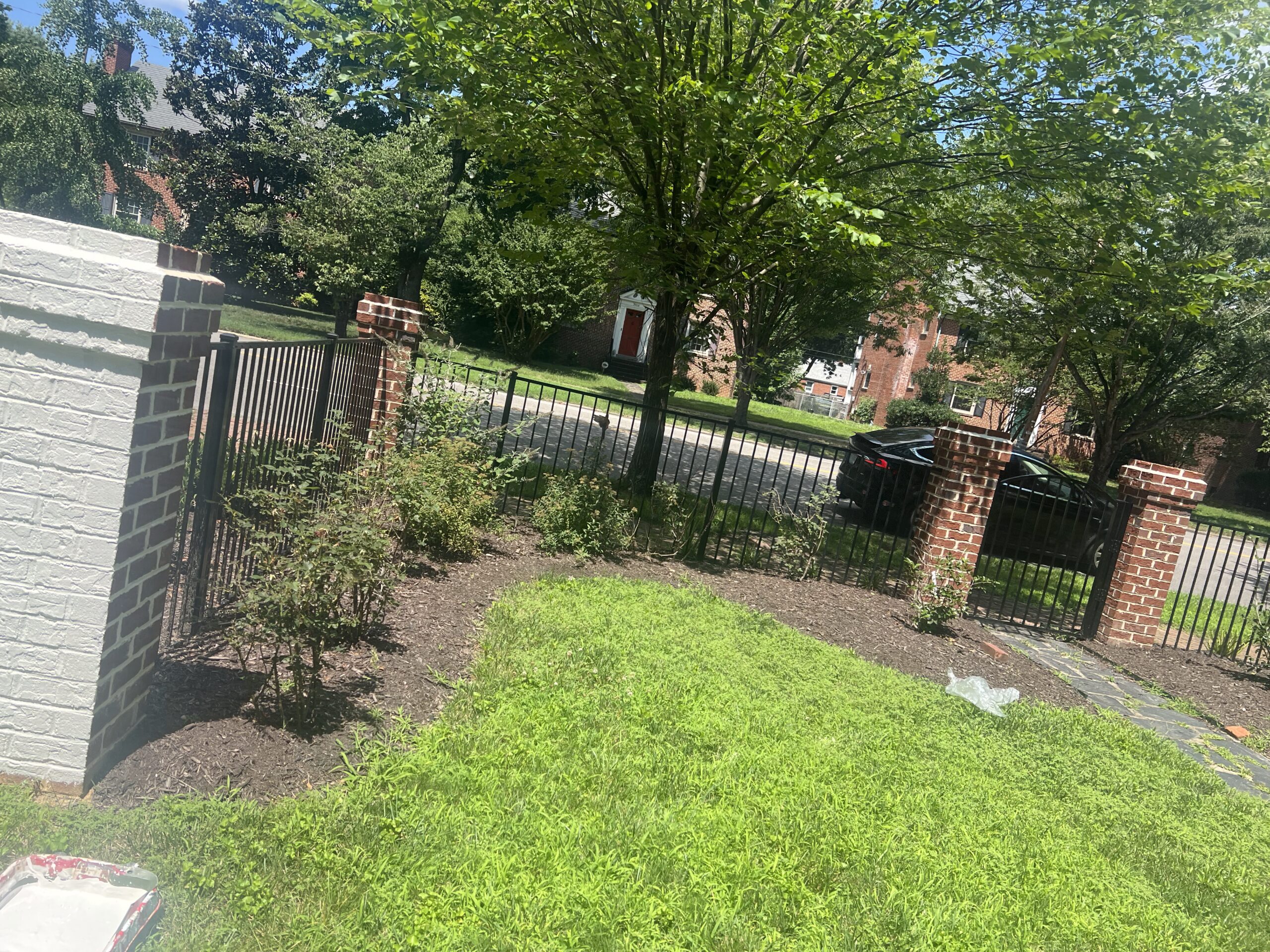 Iron fence with painted brick columns