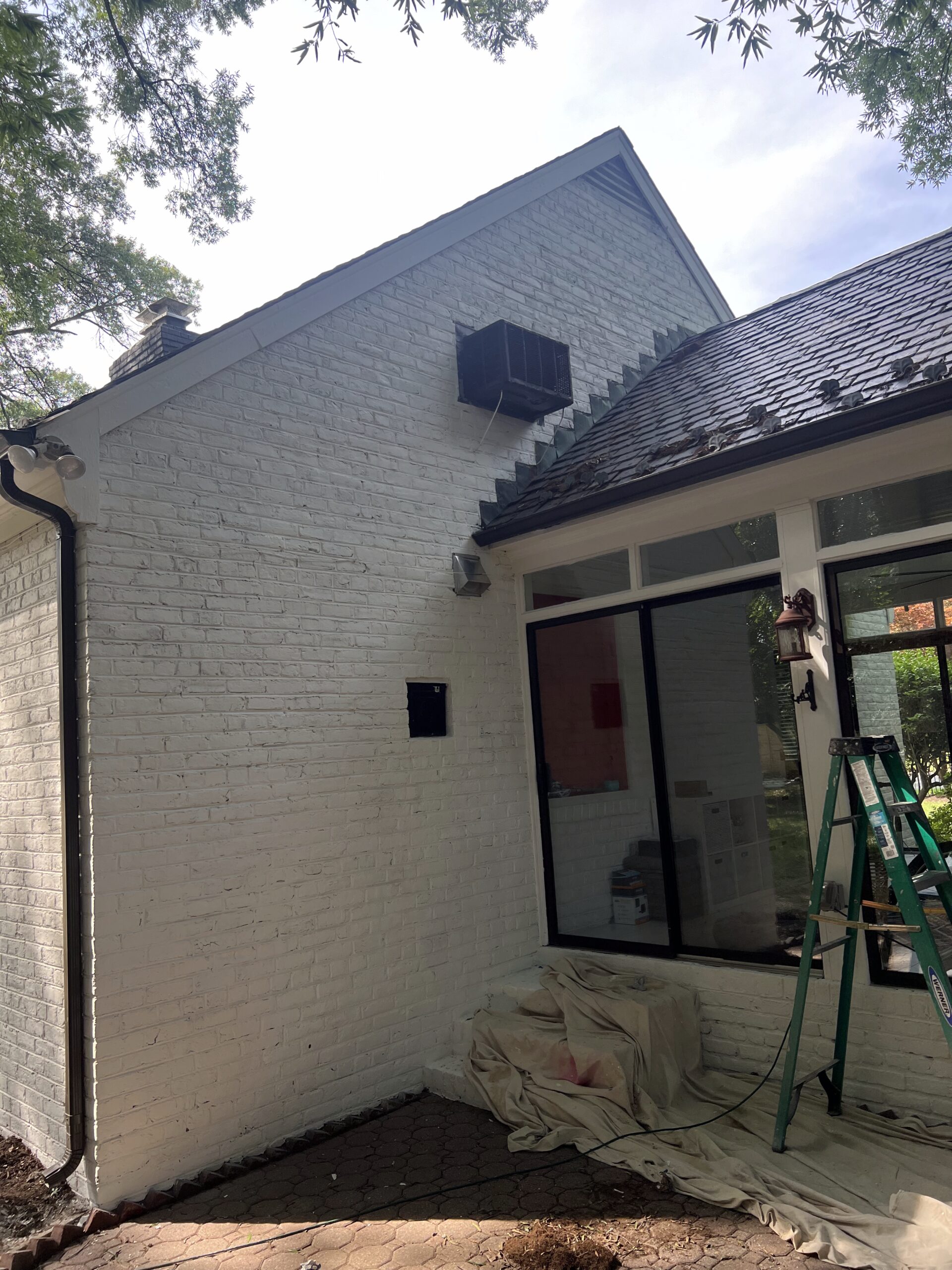 White painted house with sunroom addition