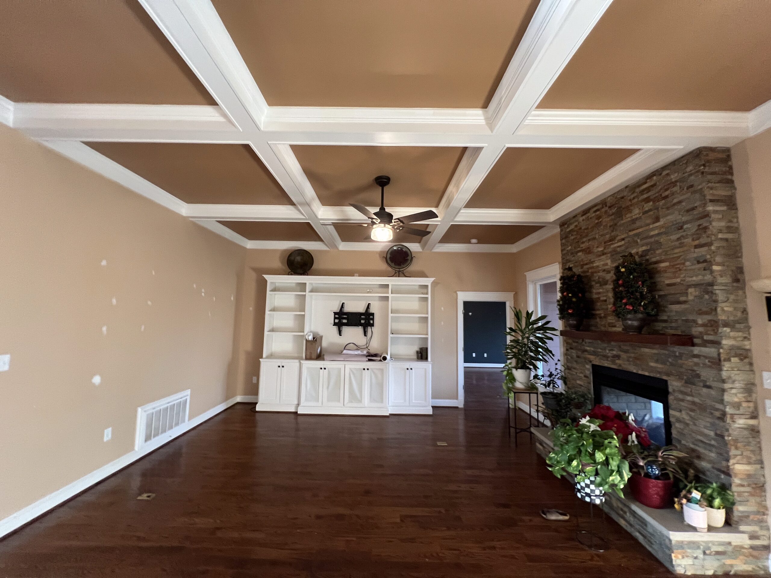 Living room with painted coffered ceiling and fireplace