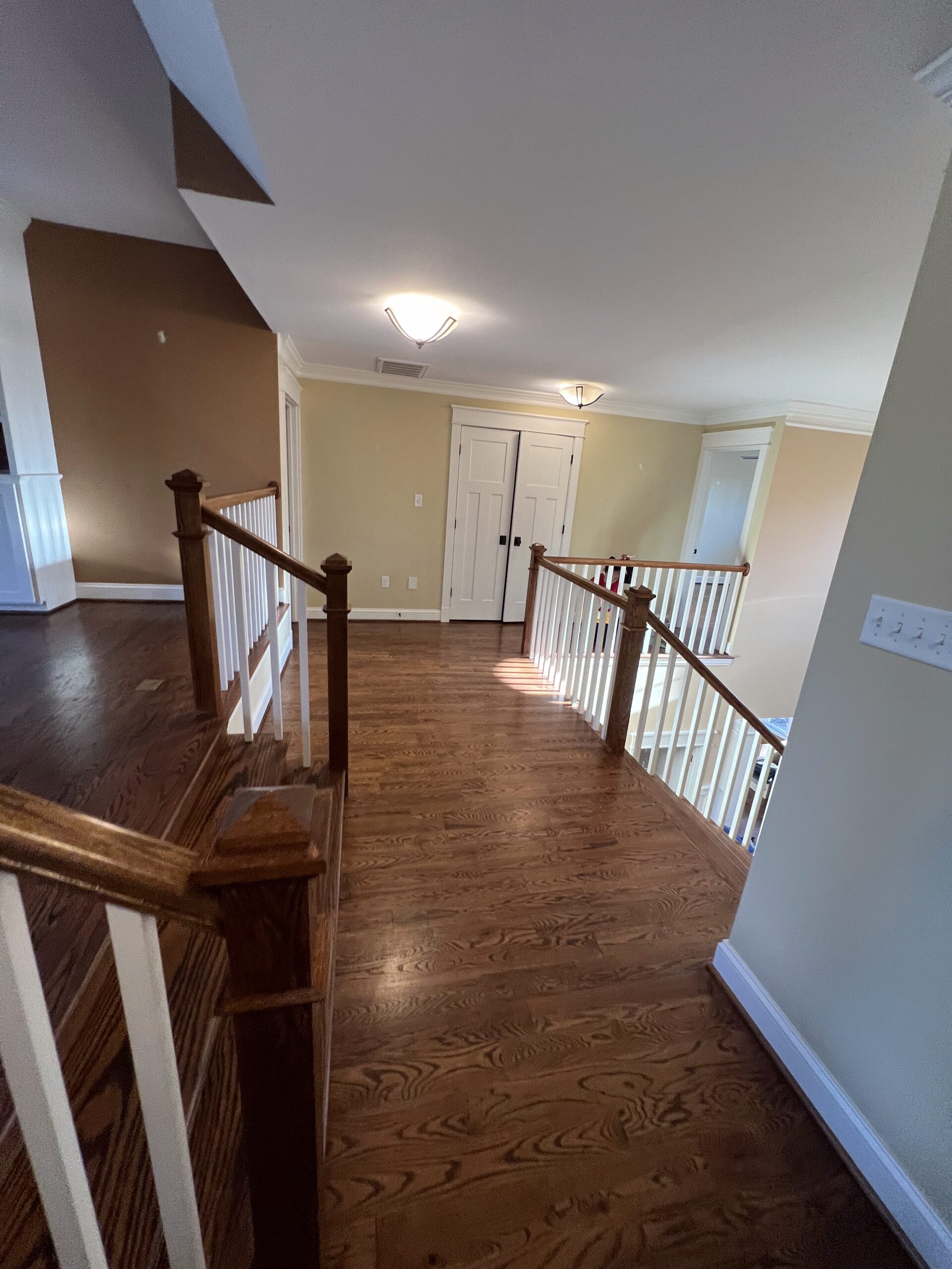 Staircase landing with painted railings and trim
