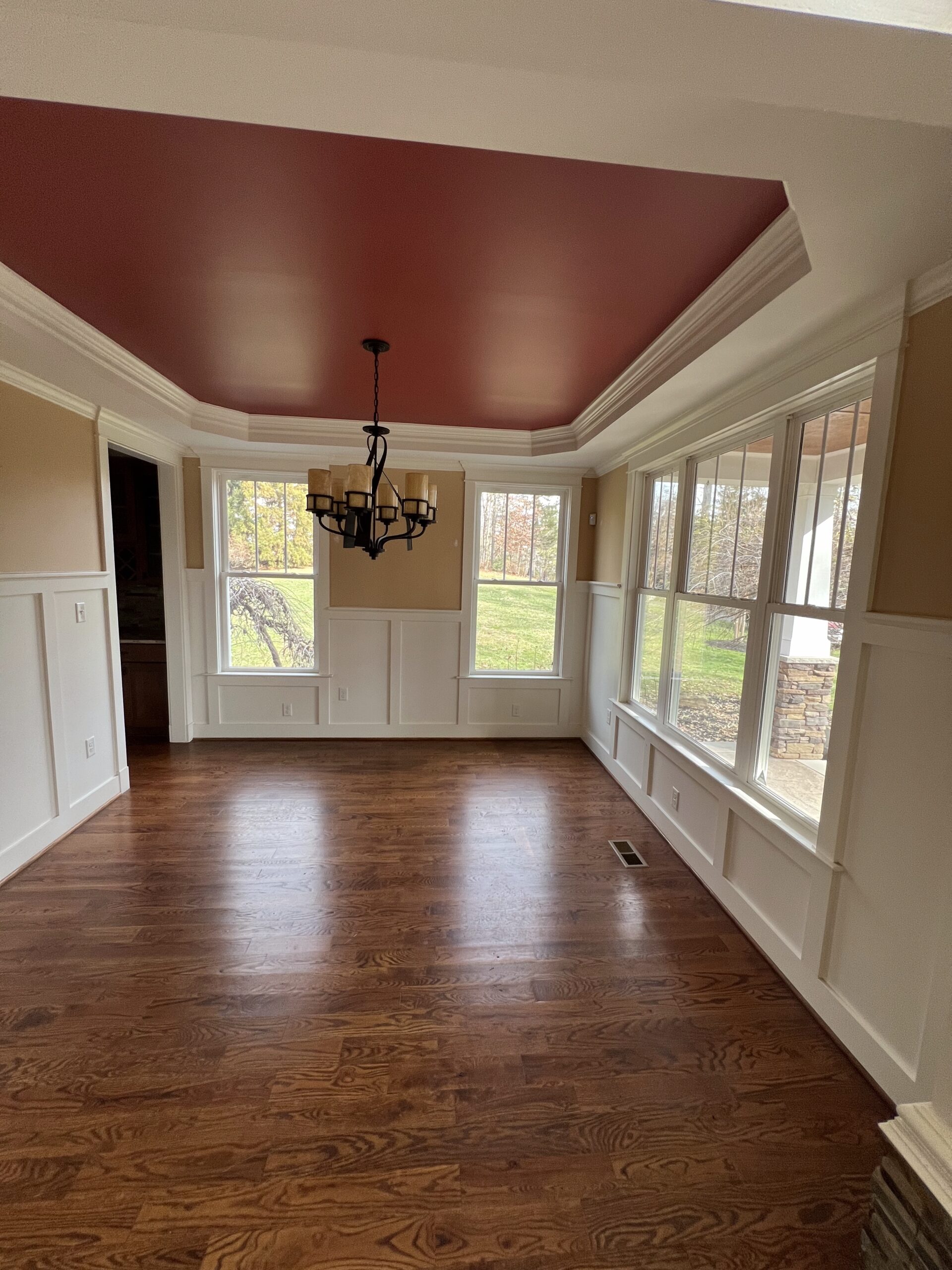Sunroom with bold red painted ceiling