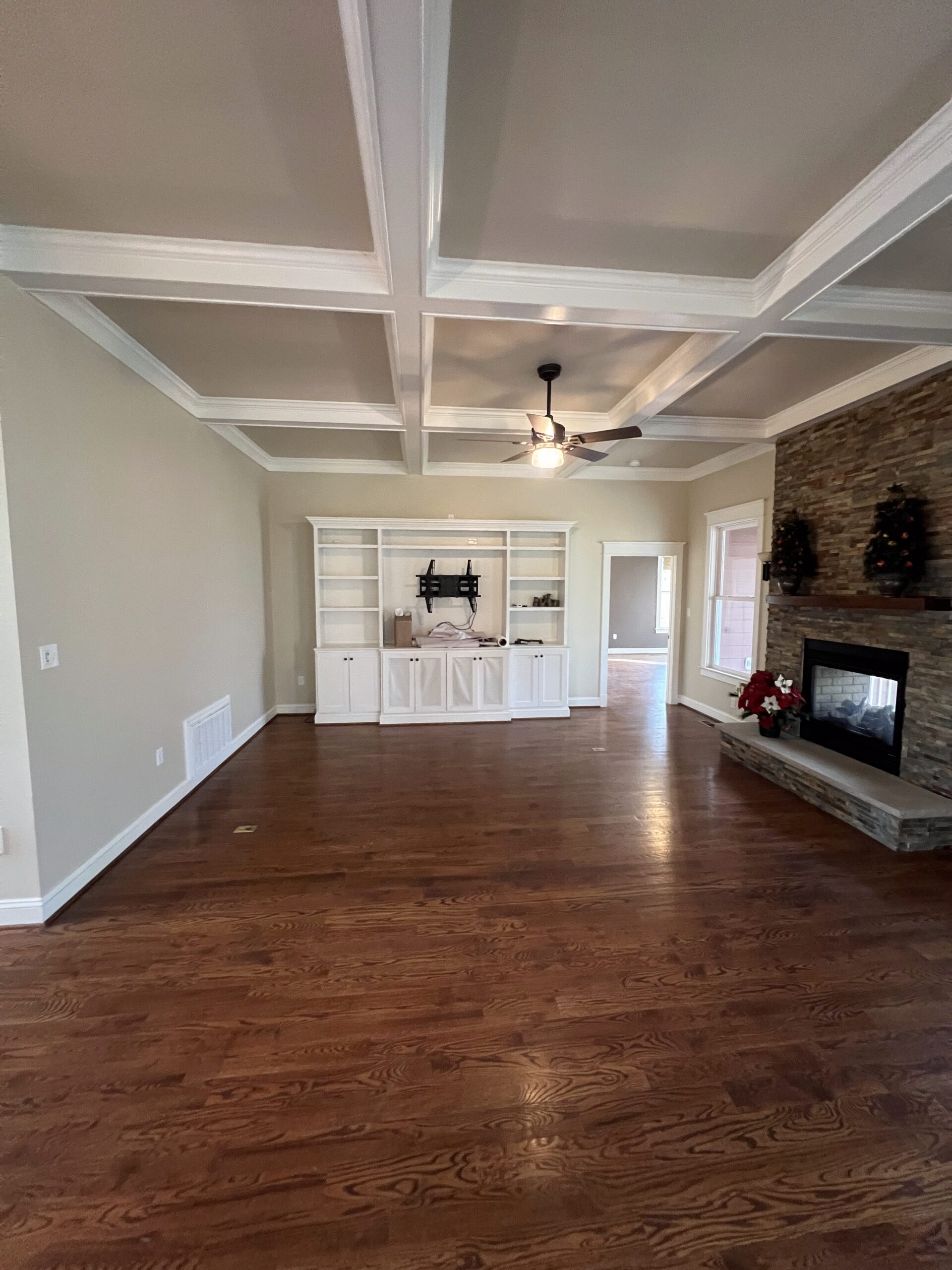 Family room with painted coffered ceiling and built-ins